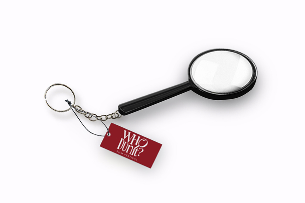 mockup photo of a mini magnifying glass keychain with a red tag with the WhoDunit? logo on it